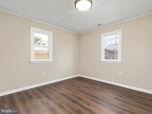 unfurnished room featuring dark wood-type flooring, ornamental molding, and a textured ceiling