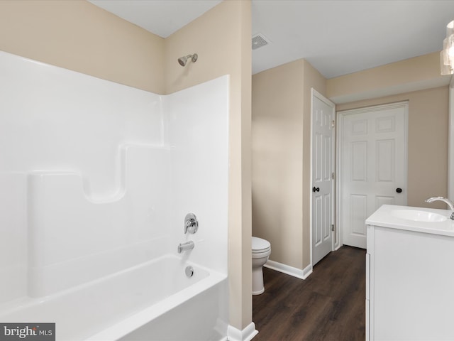 full bathroom featuring hardwood / wood-style flooring, vanity, toilet, and bathtub / shower combination