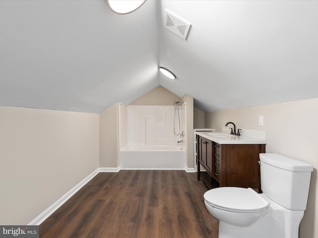 full bathroom featuring lofted ceiling, toilet, shower / bathing tub combination, vanity, and hardwood / wood-style floors