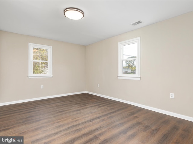 unfurnished room featuring dark wood-type flooring