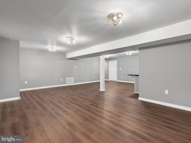 basement with dark hardwood / wood-style floors