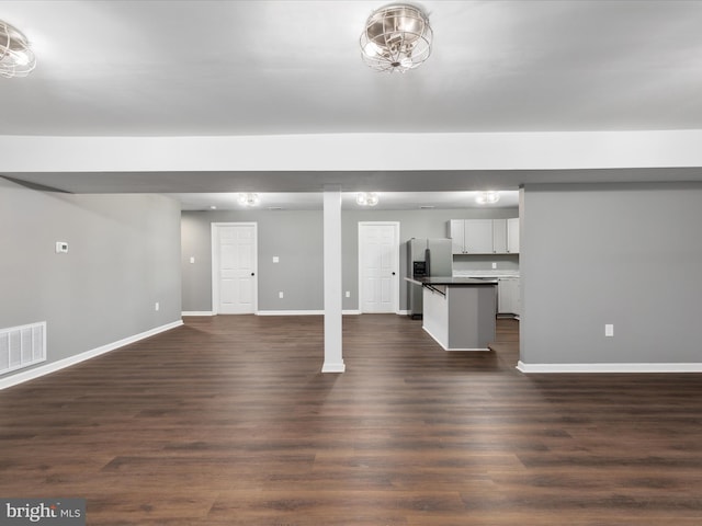 unfurnished living room with dark wood-type flooring