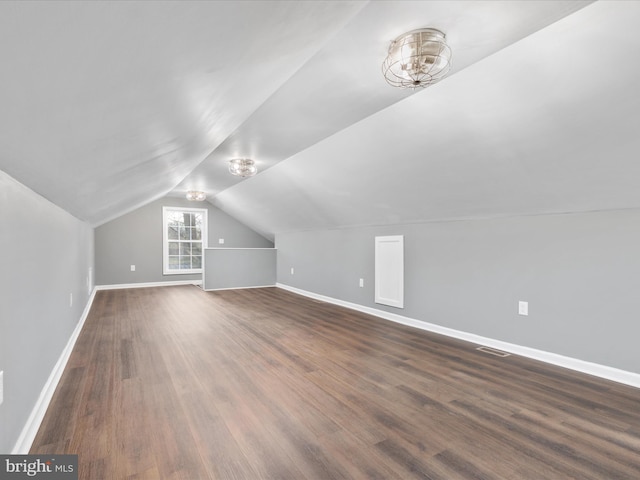 bonus room featuring lofted ceiling and dark wood-type flooring