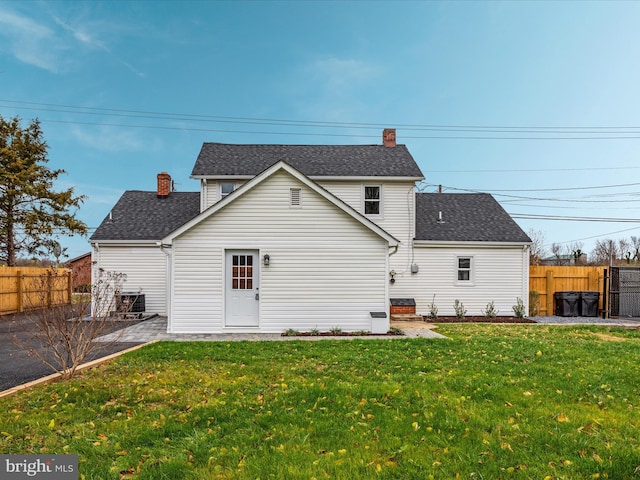 rear view of house featuring a yard