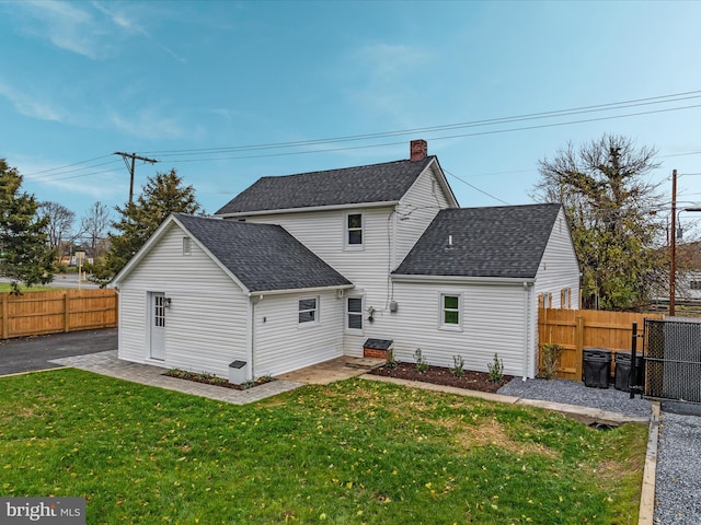 rear view of property with a yard