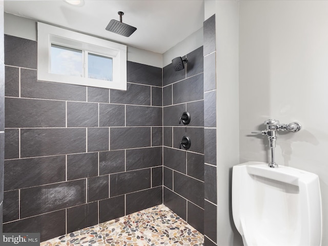 bathroom with tiled shower