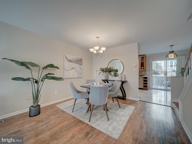 dining room featuring an inviting chandelier and light hardwood / wood-style flooring