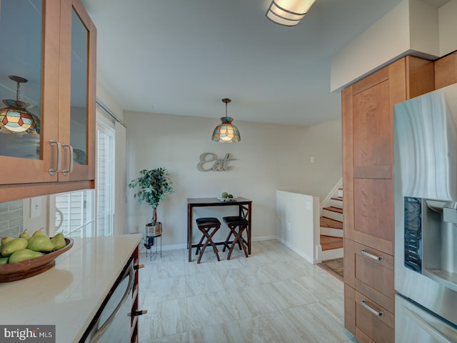 kitchen featuring dishwasher, decorative light fixtures, and stainless steel fridge with ice dispenser