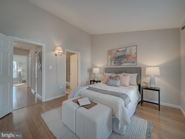 bedroom with lofted ceiling and light hardwood / wood-style flooring