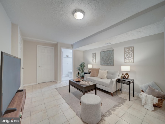 tiled living room featuring a textured ceiling