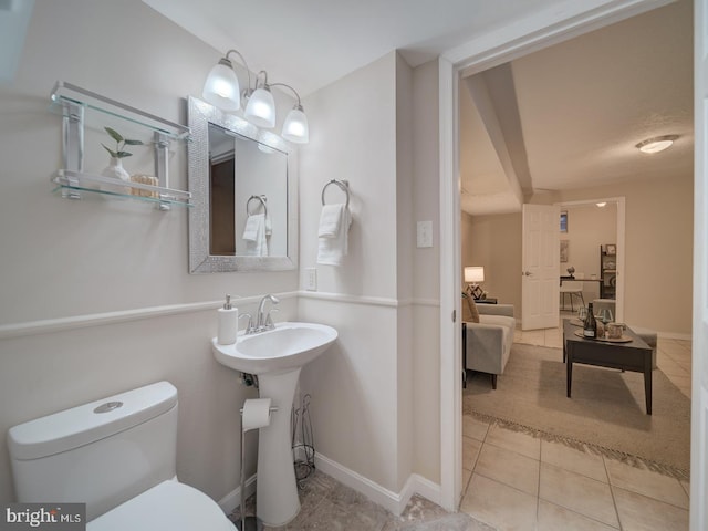 bathroom featuring tile patterned flooring, sink, and toilet