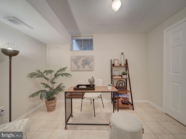 home office featuring a textured ceiling and light tile patterned floors