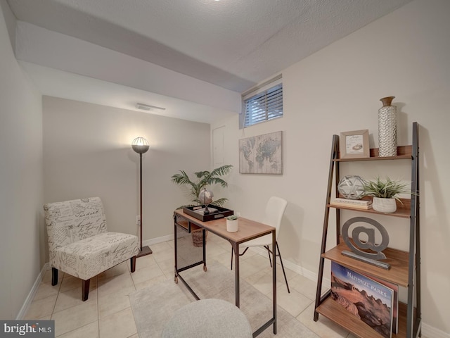 office space with a textured ceiling and light tile patterned floors