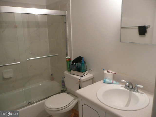 full bathroom featuring shower / bath combination with glass door, vanity, and toilet