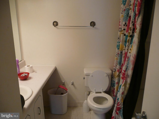 bathroom featuring tile patterned flooring, vanity, and toilet