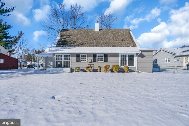 view of snow covered rear of property