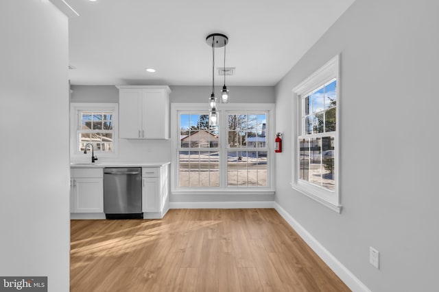 unfurnished dining area with light wood-type flooring and sink