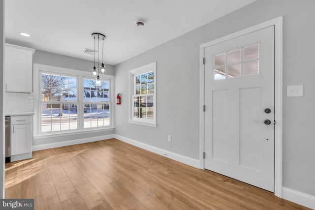 foyer entrance with light hardwood / wood-style flooring