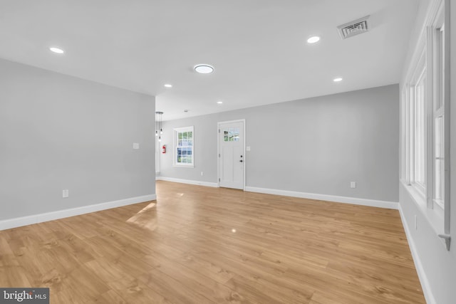 empty room with light hardwood / wood-style floors