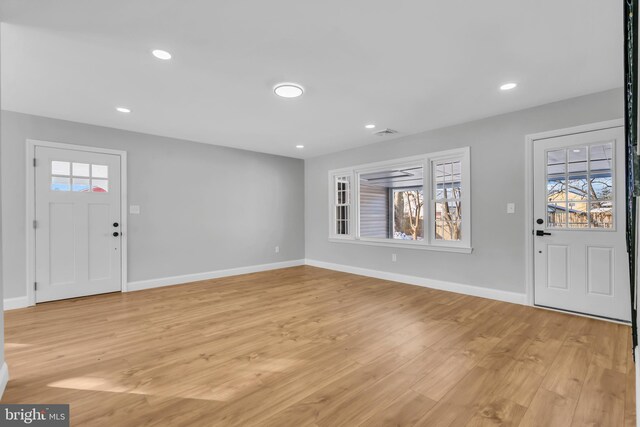 entrance foyer featuring light wood-type flooring and a wealth of natural light