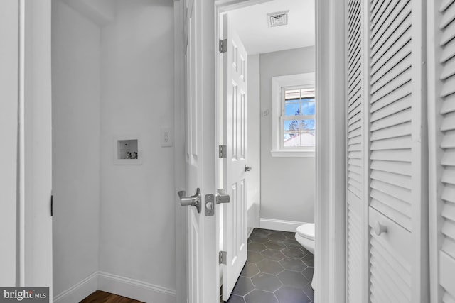 bathroom with tile patterned flooring and toilet