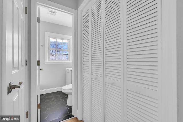 bathroom featuring tile patterned flooring and toilet