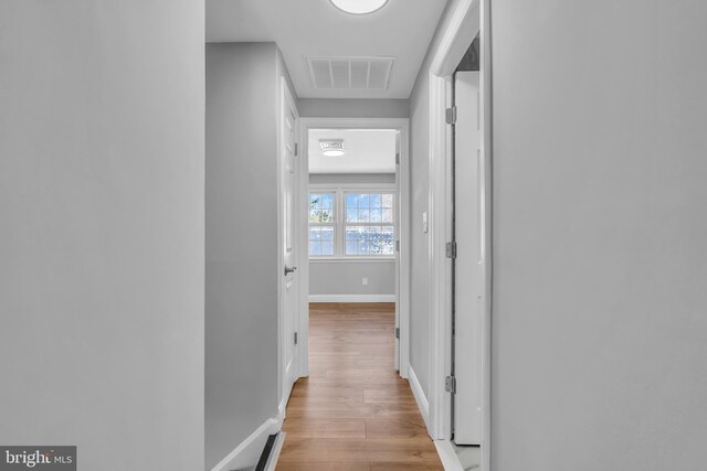 corridor with light hardwood / wood-style flooring