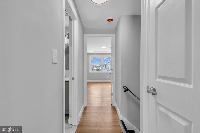 corridor with light hardwood / wood-style flooring