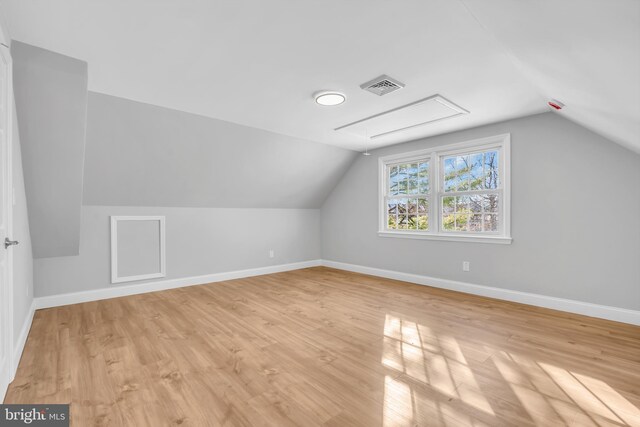 bonus room with light hardwood / wood-style flooring and vaulted ceiling