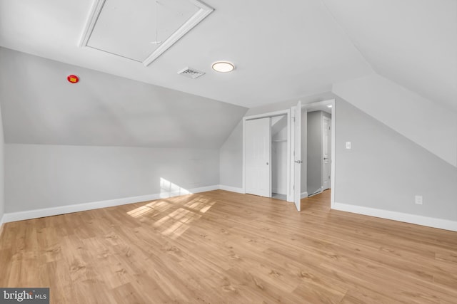 additional living space with lofted ceiling and light wood-type flooring