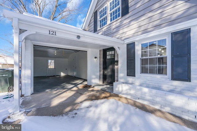 doorway to property with a garage