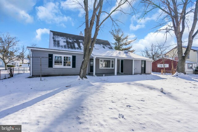 view of snow covered back of property