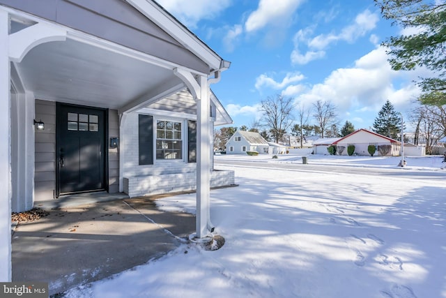 view of snow covered property entrance