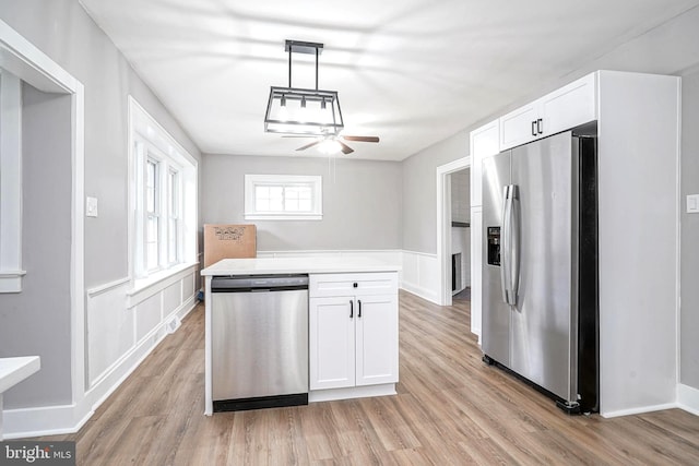 kitchen featuring ceiling fan, stainless steel appliances, light hardwood / wood-style flooring, pendant lighting, and white cabinets