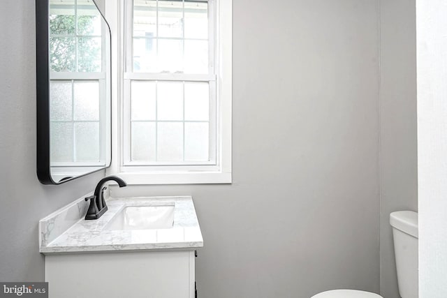 bathroom featuring vanity and toilet