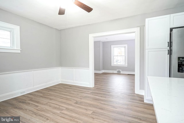 unfurnished room featuring ceiling fan and light hardwood / wood-style floors