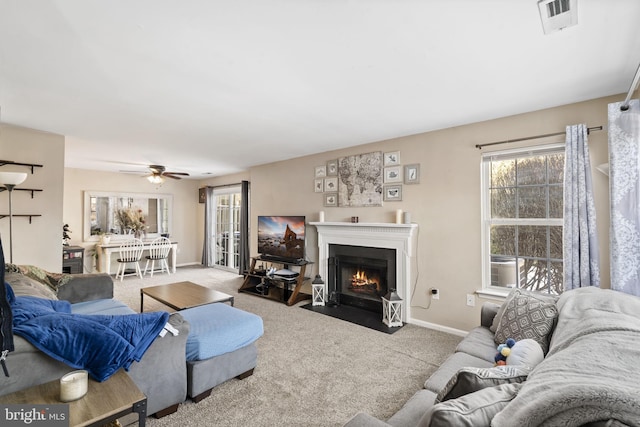 carpeted living room with ceiling fan