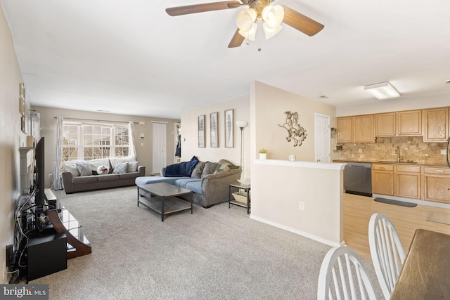 carpeted living room with ceiling fan and sink