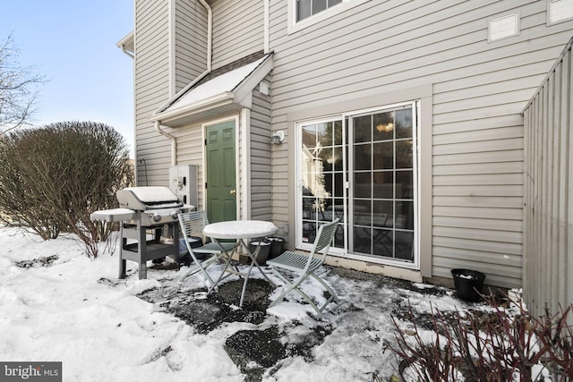 snow covered patio with grilling area