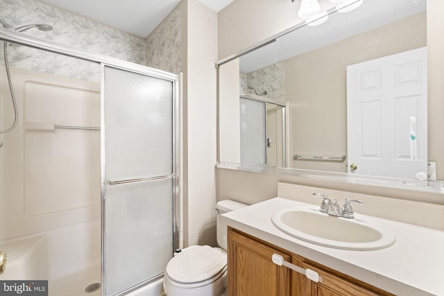 bathroom with vanity, toilet, and walk in shower