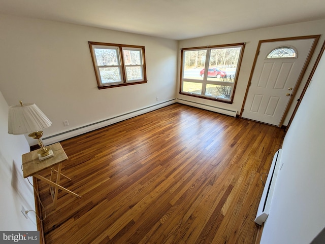 entrance foyer featuring hardwood / wood-style floors and a baseboard heating unit