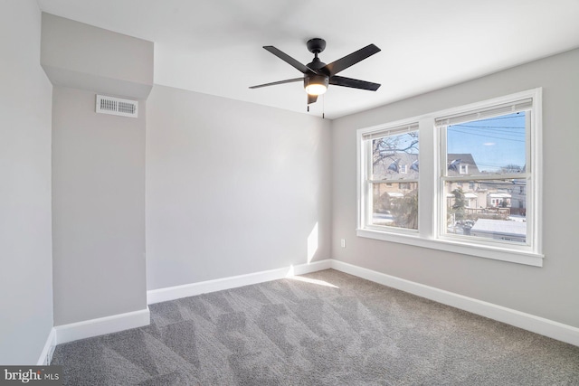 carpeted empty room featuring ceiling fan