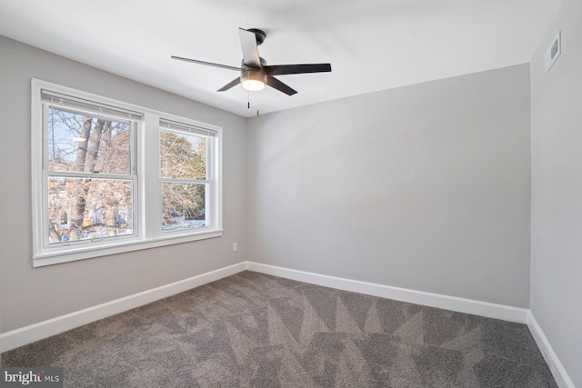 empty room featuring carpet floors and ceiling fan