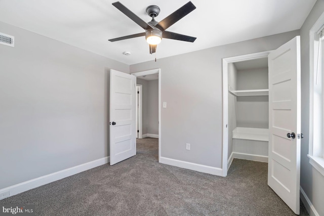 unfurnished bedroom featuring carpet flooring, ceiling fan, and a closet