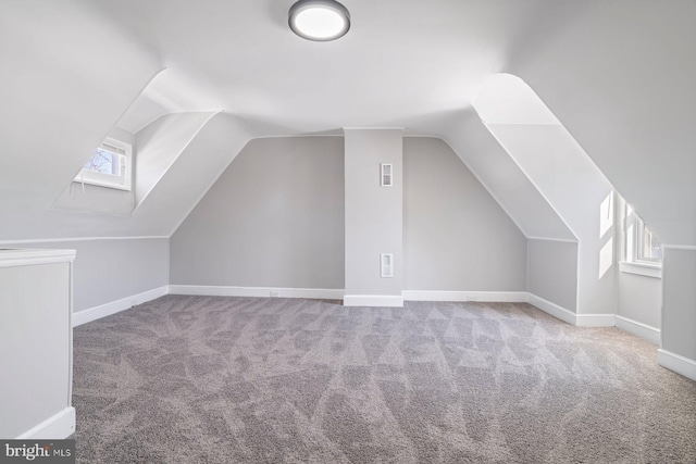 bonus room featuring carpet floors, plenty of natural light, and lofted ceiling