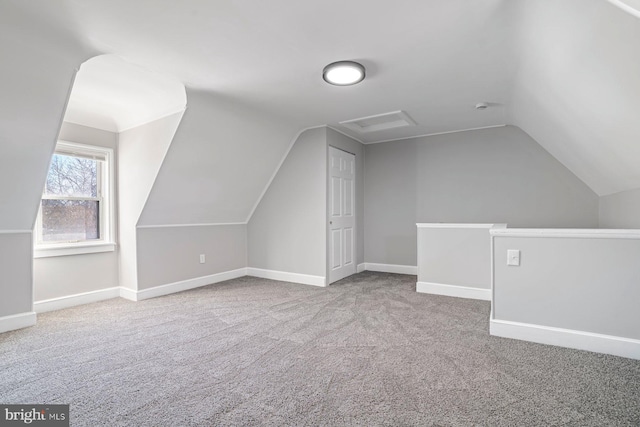 bonus room with carpet and vaulted ceiling