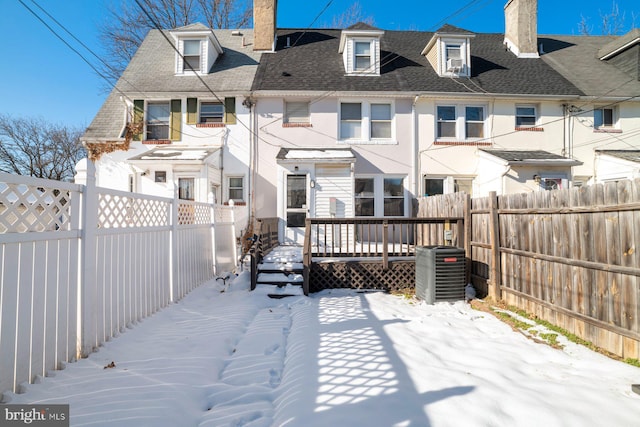 back of property featuring a deck and central AC