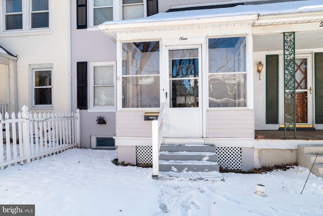 view of snow covered property entrance