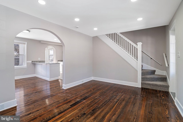 unfurnished living room with dark hardwood / wood-style flooring