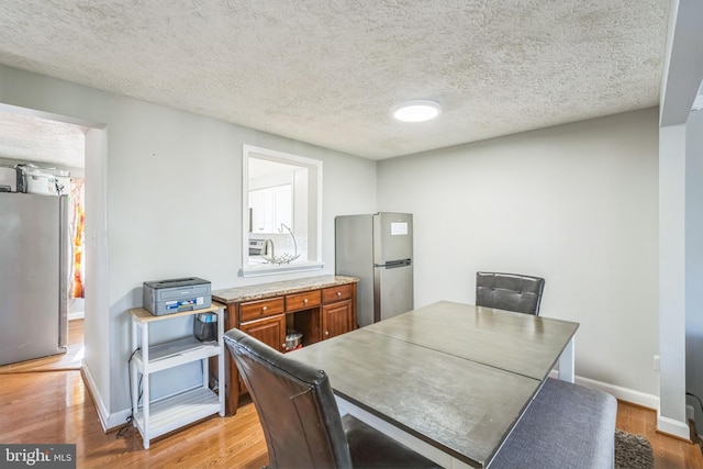 office area with wood-type flooring and a textured ceiling